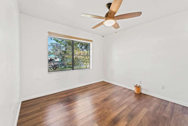 empty room featuring ceiling fan and dark hardwood / wood-style flooring