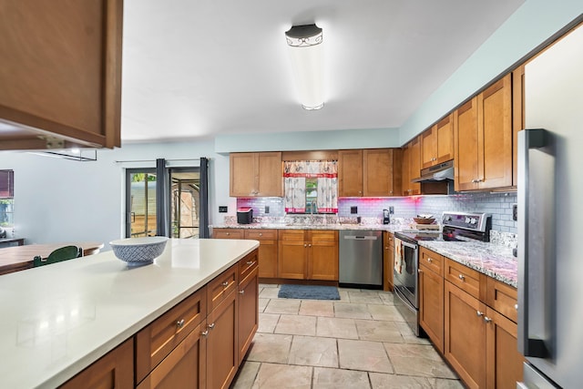 kitchen featuring decorative backsplash, sink, and appliances with stainless steel finishes