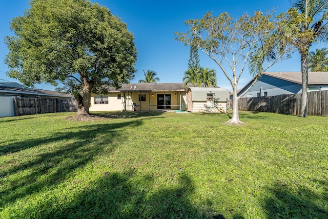 rear view of house featuring a lawn