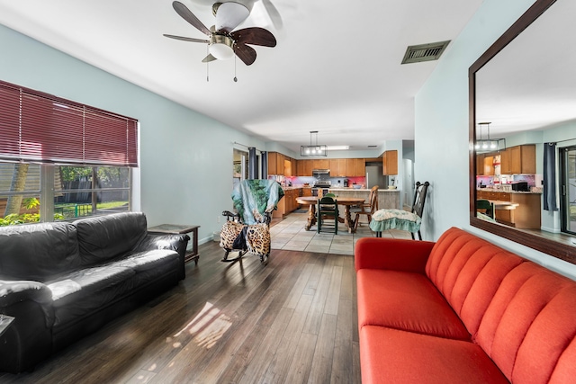 living room featuring ceiling fan and wood-type flooring