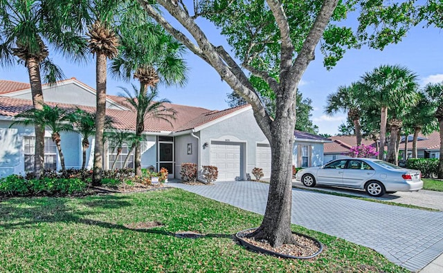 view of front of home with a front lawn and a garage