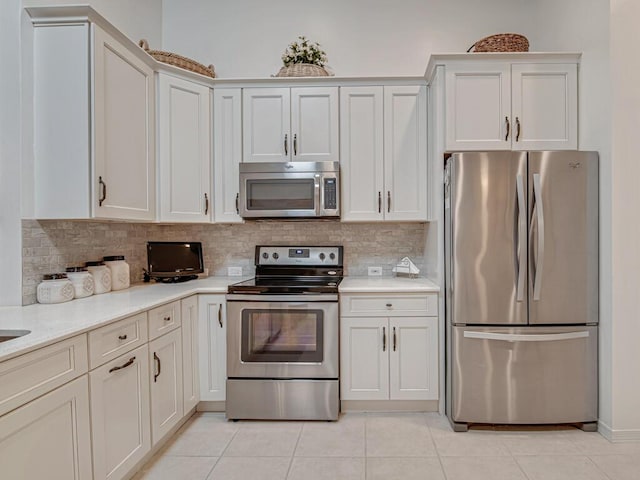 kitchen featuring backsplash, white cabinetry, and appliances with stainless steel finishes