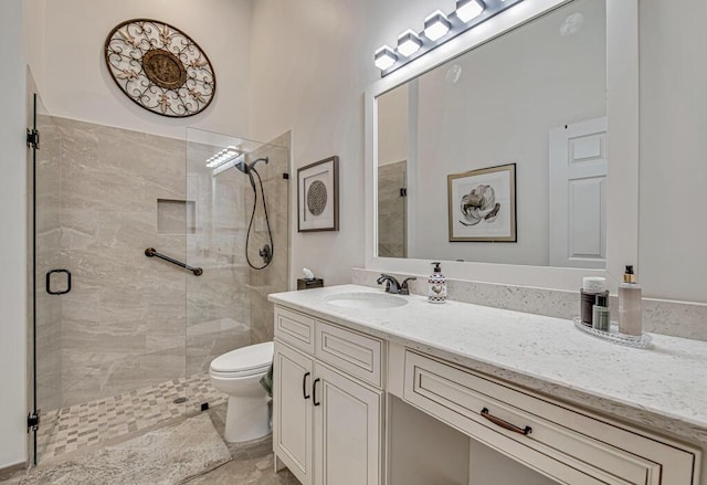 bathroom featuring vanity, toilet, and an enclosed shower