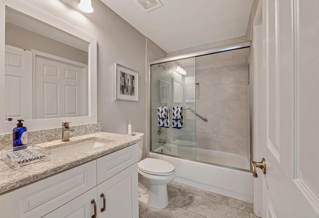 full bathroom featuring tile patterned floors, vanity, toilet, and combined bath / shower with glass door