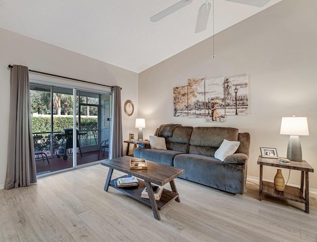 living room featuring ceiling fan, high vaulted ceiling, and light wood-type flooring