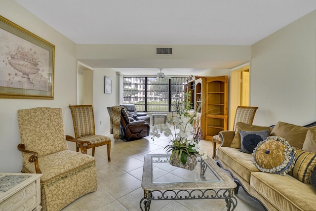 living room with ceiling fan and light tile patterned floors