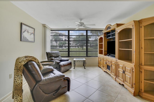 sitting room featuring floor to ceiling windows, light tile patterned floors, and ceiling fan