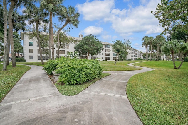 view of property's community with a lawn