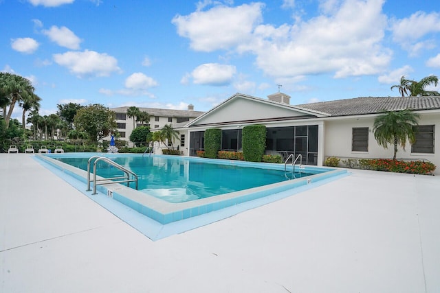 view of swimming pool with a patio area