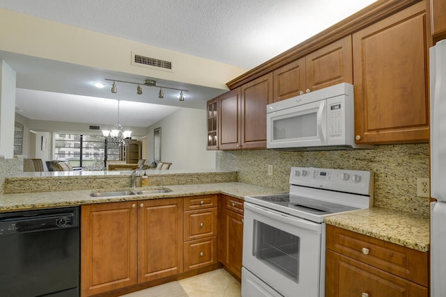 kitchen featuring white appliances, sink, a textured ceiling, a notable chandelier, and light tile patterned flooring