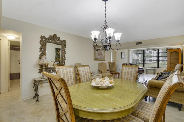 tiled dining area with an inviting chandelier