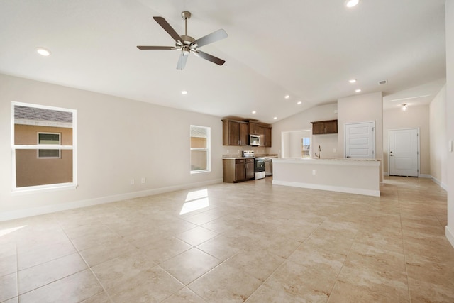 unfurnished living room featuring ceiling fan, light tile patterned floors, and vaulted ceiling