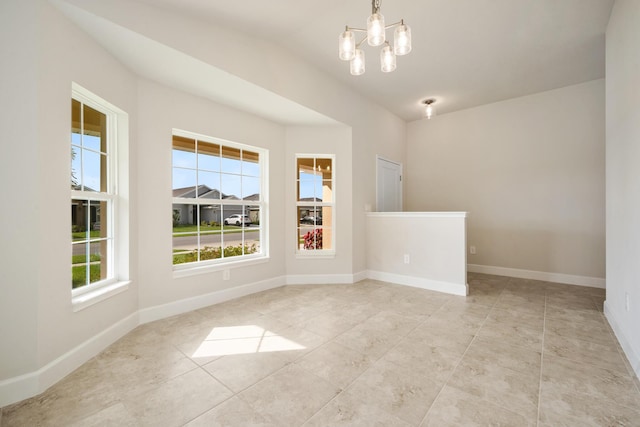 unfurnished room with a wealth of natural light, light tile patterned flooring, vaulted ceiling, and a notable chandelier