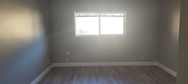 unfurnished room featuring dark wood-type flooring