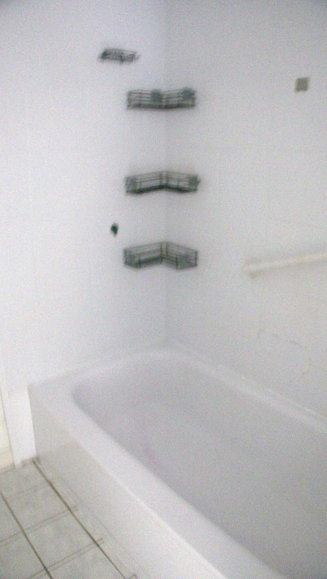 bathroom featuring tile patterned floors and a tub to relax in