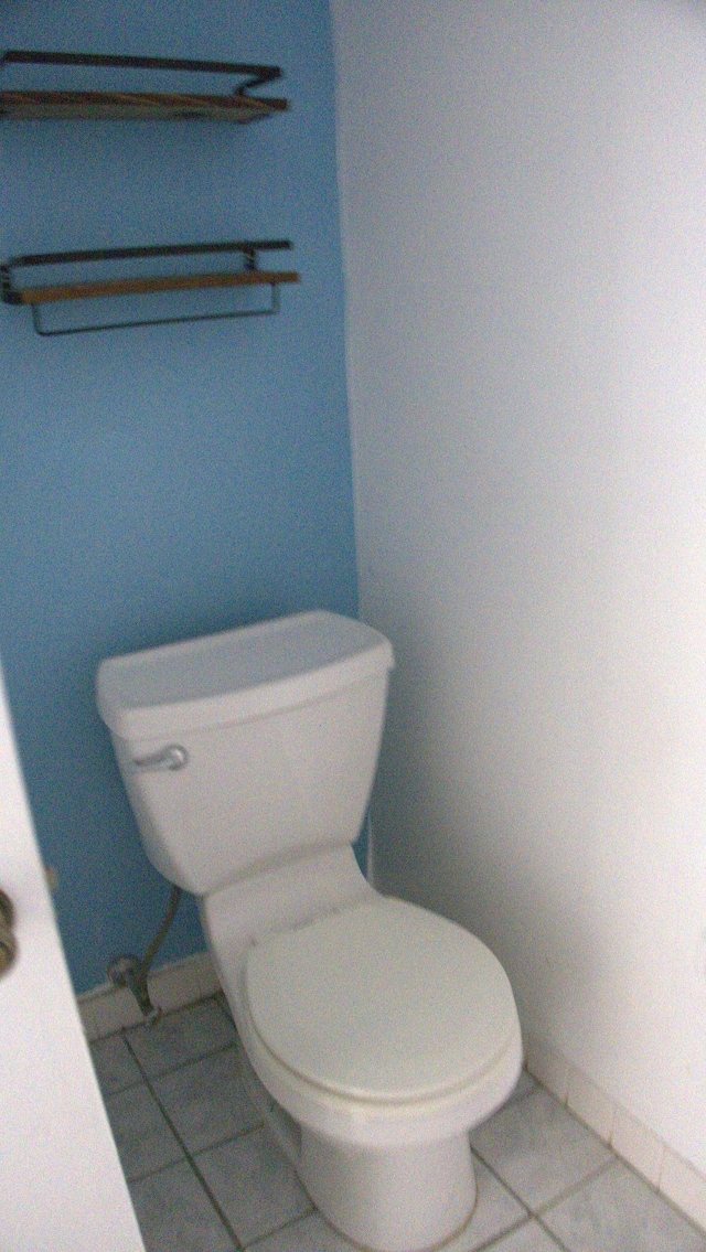 bathroom featuring tile patterned flooring and toilet