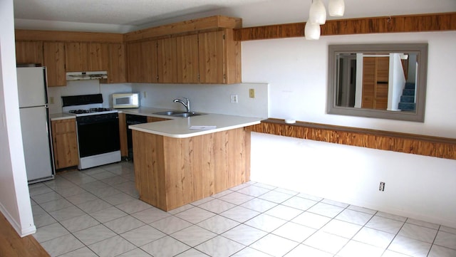 kitchen featuring kitchen peninsula, white appliances, light tile patterned flooring, and sink