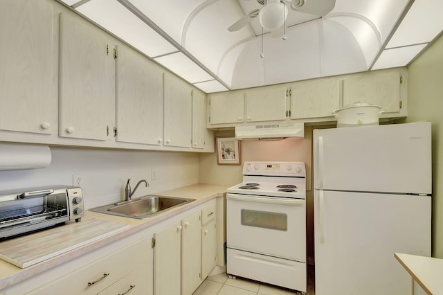 kitchen featuring white appliances, sink, ceiling fan, cream cabinetry, and light tile patterned flooring