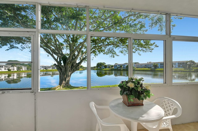 sunroom / solarium with plenty of natural light and a water view