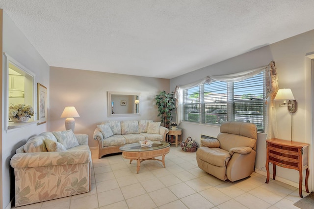 tiled living room featuring a textured ceiling