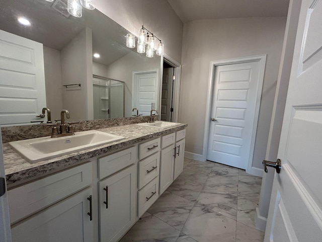 bathroom featuring a shower with door, vanity, and lofted ceiling