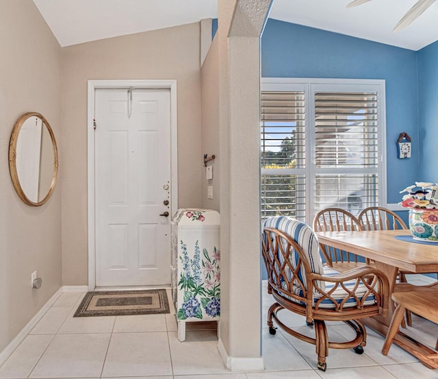 tiled foyer entrance featuring lofted ceiling