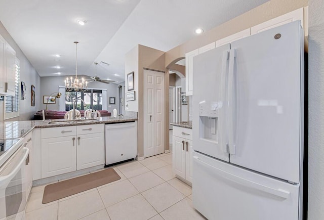 kitchen featuring white cabinetry, lofted ceiling, ceiling fan, and white appliances