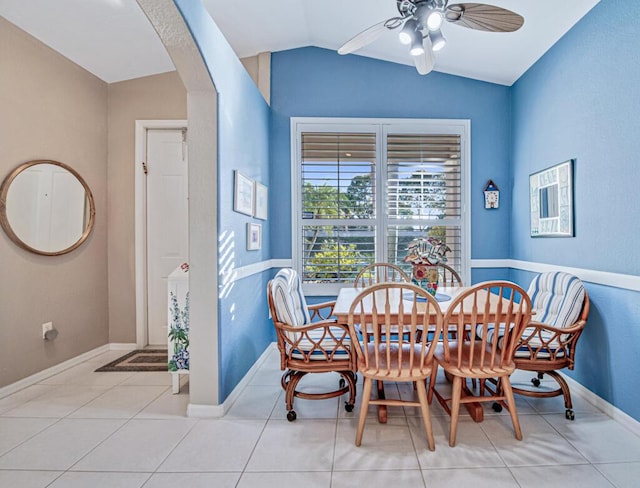 tiled dining room featuring ceiling fan and vaulted ceiling