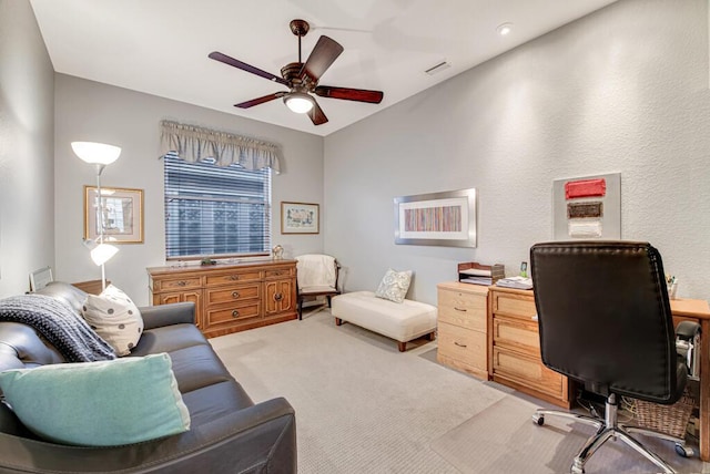 carpeted office featuring ceiling fan