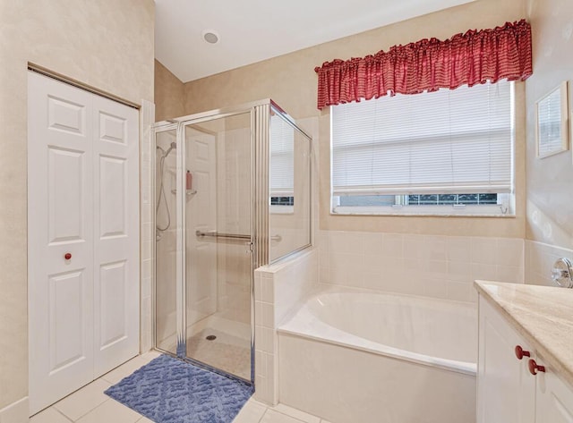 bathroom featuring tile patterned floors, vanity, and plus walk in shower