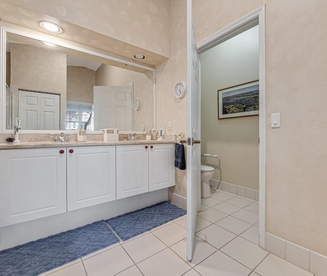 bathroom with tile patterned flooring, vanity, and toilet