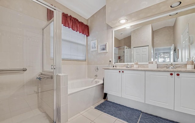 bathroom featuring tile patterned flooring, vanity, separate shower and tub, and lofted ceiling