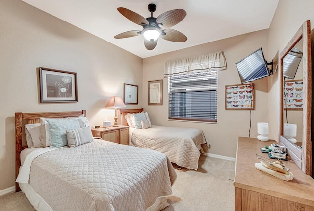 bedroom with ceiling fan and light carpet