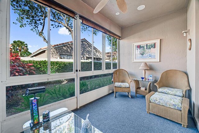 sunroom / solarium featuring ceiling fan