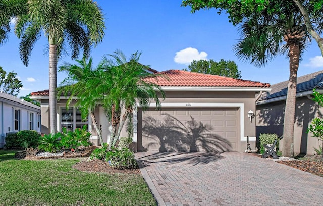 mediterranean / spanish-style house with a garage