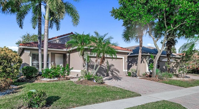 view of front facade with a front yard and a garage