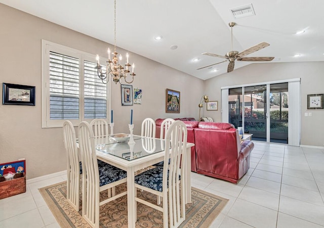 tiled dining room with ceiling fan with notable chandelier, a healthy amount of sunlight, and lofted ceiling