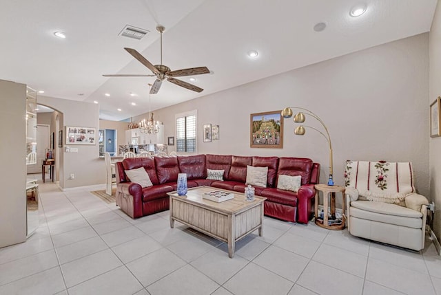 tiled living room with ceiling fan with notable chandelier and lofted ceiling