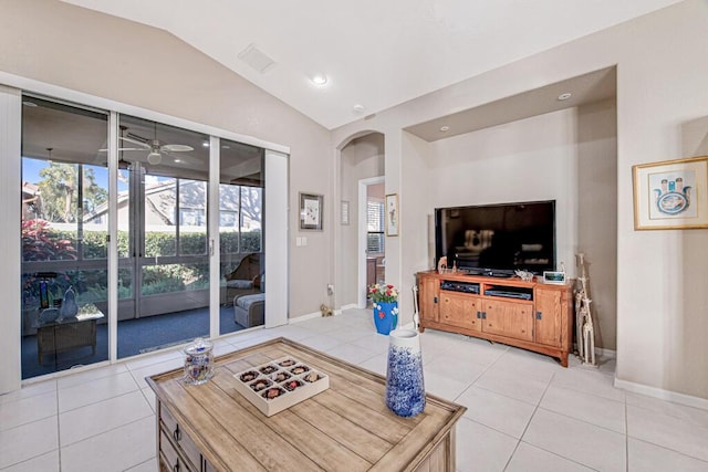 living room with ceiling fan, light tile patterned flooring, and vaulted ceiling