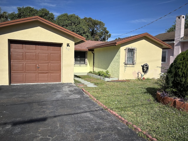 view of front facade with a front yard and a garage