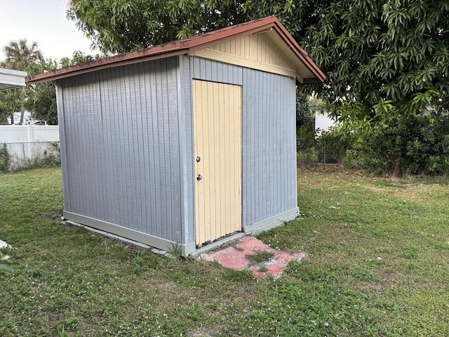 view of outbuilding with a lawn