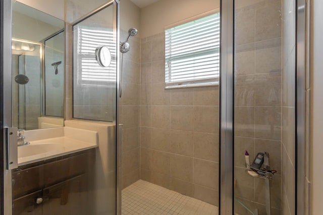 bathroom featuring vanity and an enclosed shower