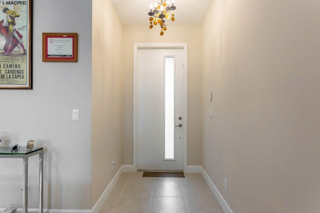 tiled entrance foyer with an inviting chandelier