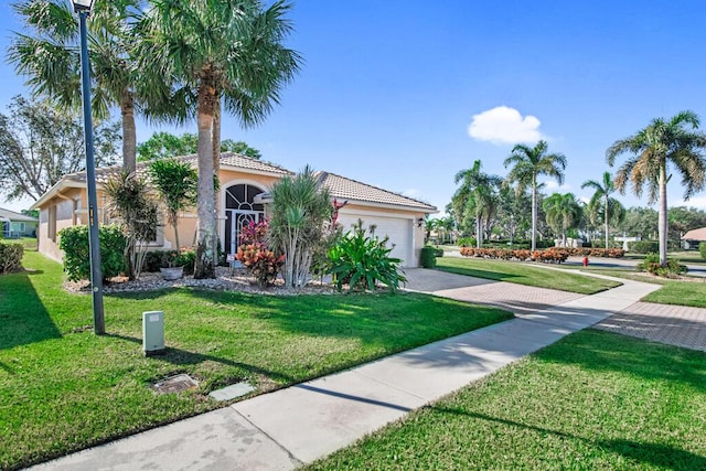 view of front of property with a front yard and a garage