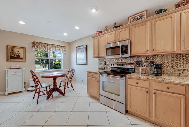 kitchen with tasteful backsplash, light brown cabinetry, light tile patterned flooring, and appliances with stainless steel finishes