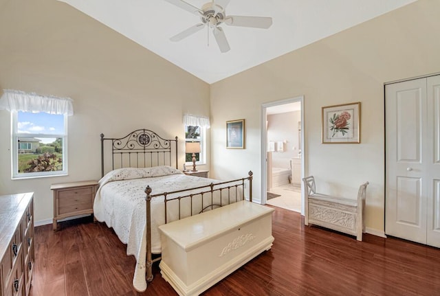 bedroom featuring ceiling fan, dark wood-type flooring, high vaulted ceiling, ensuite bathroom, and a closet