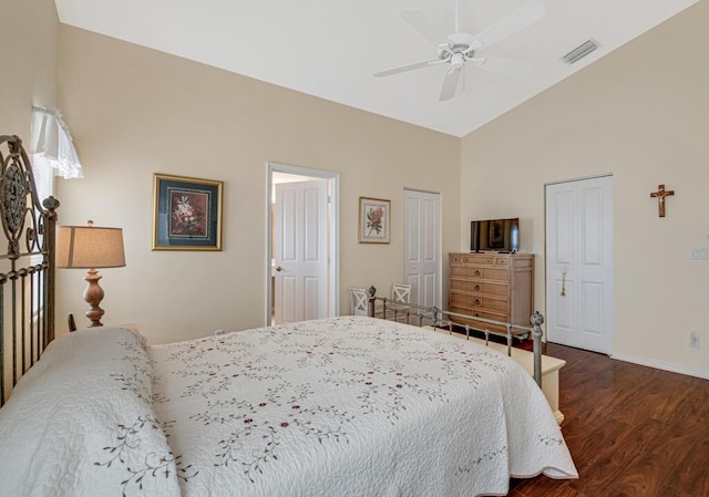 bedroom featuring dark hardwood / wood-style flooring, vaulted ceiling, and ceiling fan