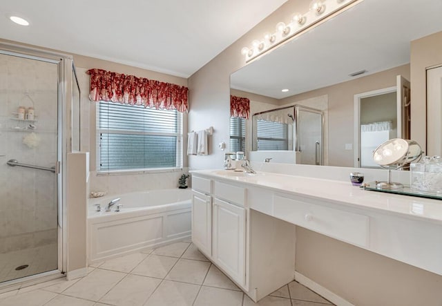 bathroom featuring tile patterned floors, vanity, and shower with separate bathtub