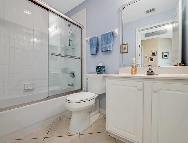 full bathroom with tile patterned flooring, vanity, toilet, and shower / bath combination with glass door