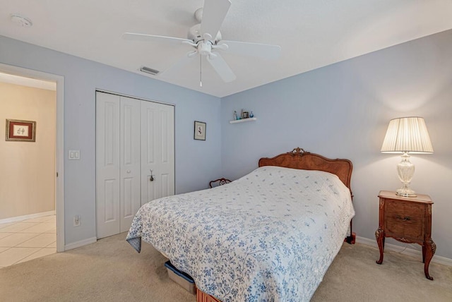 carpeted bedroom with ceiling fan and a closet